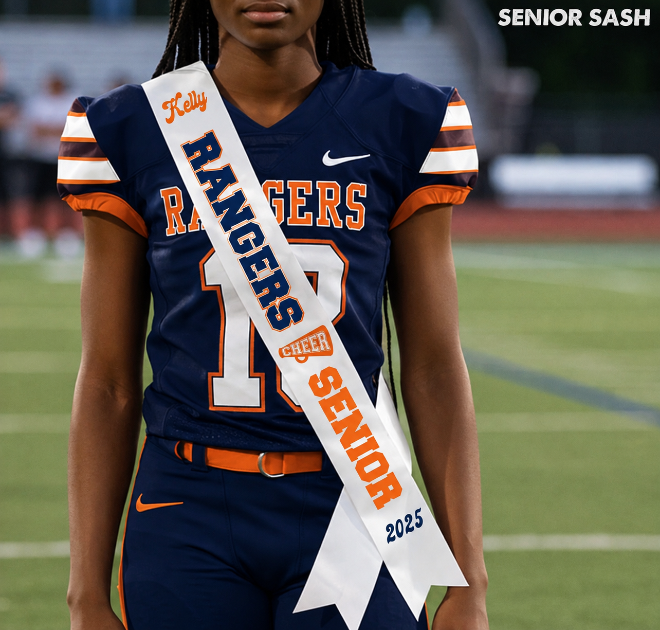 A person wearing a navy and orange football uniform stands on a field holding a white sash that reads Kelly Rangers Senior 2025. A Nike logo is visible on the jersey, and the words SENIOR SASH appear in the top right corner.
